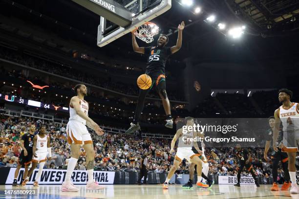 Wooga Poplar of the Miami Hurricanes reacts as he dunks the ball during the second half against the Texas Longhorns in the Elite Eight round of the...