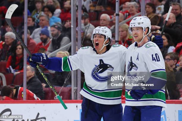 Ethan Bear and Elias Pettersson of the Vancouver Canucks celebrate a goal against the Chicago Blackhawks during the third period at United Center on...