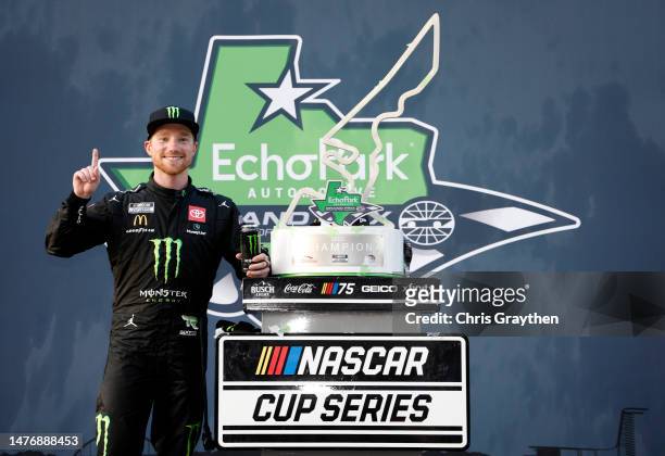 Tyler Reddick, driver of the Monster Energy Toyota, celebrates in victory lane after winning the NASCAR Cup Series EchoPark Automotive Grand Prix at...