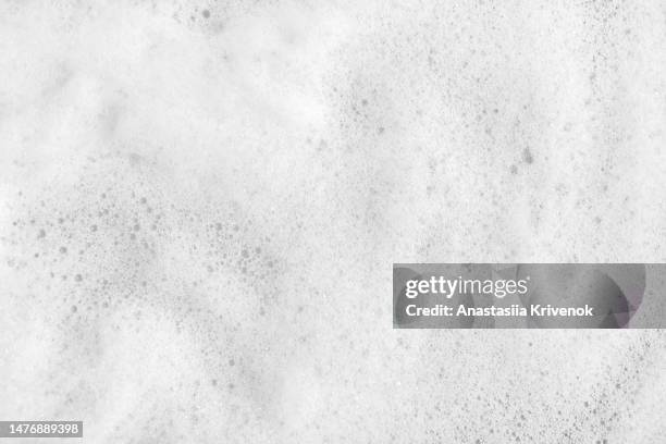 close up of soap foam floating in the water of a bathtub. - bain moussant photos et images de collection