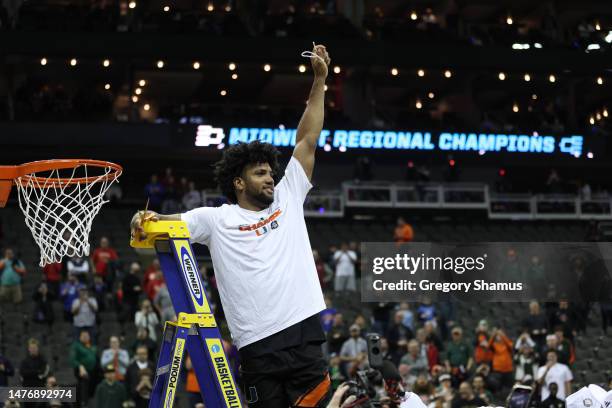 Norchad Omier of the Miami Hurricanes cuts the net after defeating the Texas Longhorns 88-81 in the Elite Eight round of the NCAA Men's Basketball...