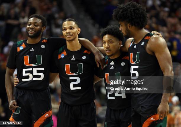 Wooga Poplar, Isaiah Wong, Nijel Pack and Norchad Omier of the Miami Hurricanes watch free throws during the second half against the Texas Longhorns...