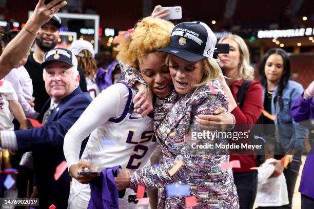 Jasmine Carson and head coach Kim Mulkey of the LSU Lady Tigers celebrate after defeating the Miami Hurricanes 54-42 in the Elite Eight round of the...