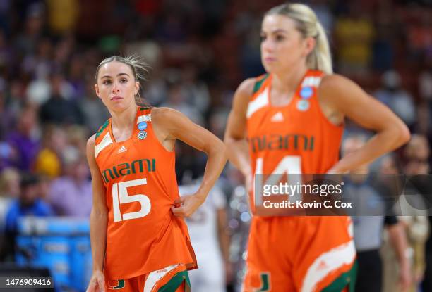Hanna Cavinder and Haley Cavinder of the Miami Hurricanes react during the fourth quarter of the game against the LSU Lady Tigers in the Elite Eight...