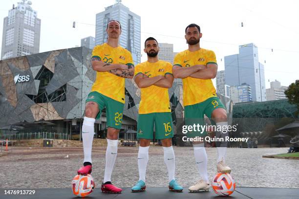 Jackson Irvine, Aziz Behich and Bailey Wright of the Socceroos pose during an Australia Socceroos Media Opportunity at Federation Square on March 27,...