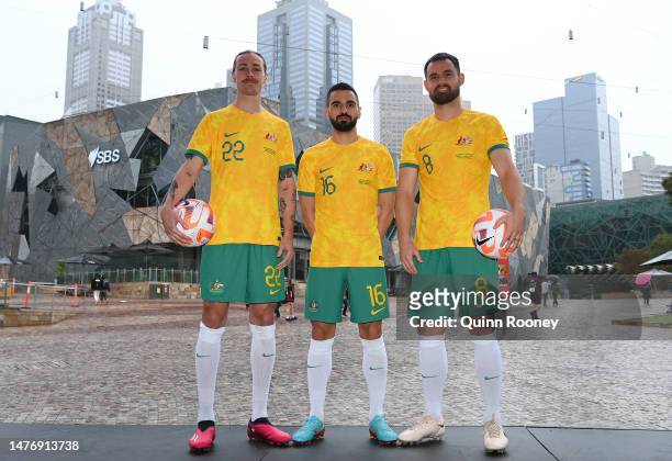 Jackson Irvine, Aziz Behich and Bailey Wright of the Socceroos pose during an Australia Socceroos Media Opportunity at Federation Square on March 27,...