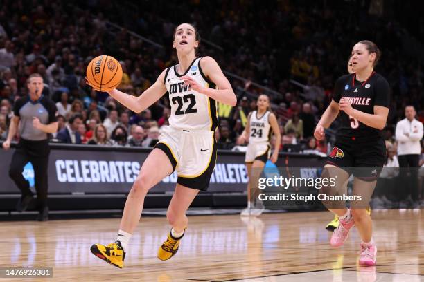 Caitlin Clark of the Iowa Hawkeyes drives to the basket during the third quarter against the Louisville Cardinals in the Elite Eight round of the...