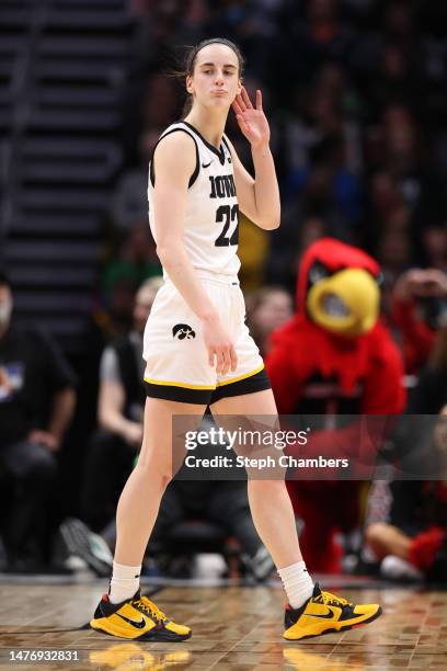 Caitlin Clark of the Iowa Hawkeyes reacts during the fourth quarter of the game against the Louisville Cardinals in the Elite Eight round of the NCAA...