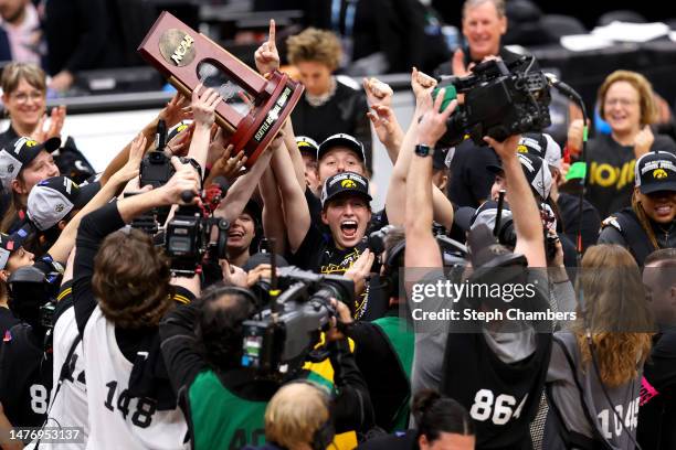 Caitlin Clark of the Iowa Hawkeyes celebrates after defeating the Louisville Cardinals 97-83 in the Elite Eight round of the NCAA Women's Basketball...