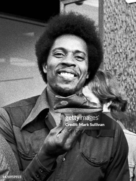 Percussionist/Singer Sam Clayton poses with a little shoe at a Little Feat award ceremony on Hollywood Blvd. In Hollywood, CA 1976.