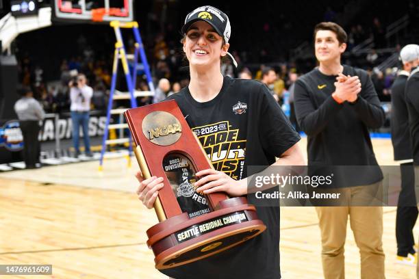 Caitlin Clark of the Iowa Hawkeyes celebrates after defeating the Louisville Cardinals 97-83 in the Elite Eight round of the NCAA Women's Basketball...