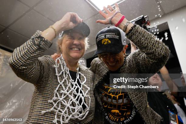 Head coach Lisa Bluder associate head coach Jan Jensen of the Iowa Hawkeyes celebrate after defeating the Louisville Cardinals 97-83 in the Elite...