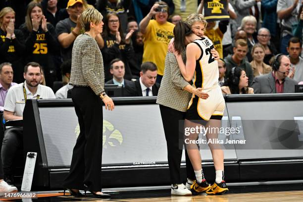Head coach Lisa Bluder and Caitlin Clark of the Iowa Hawkeyes celebrate after defeating the Louisville Cardinals in the Elite Eight round of the NCAA...