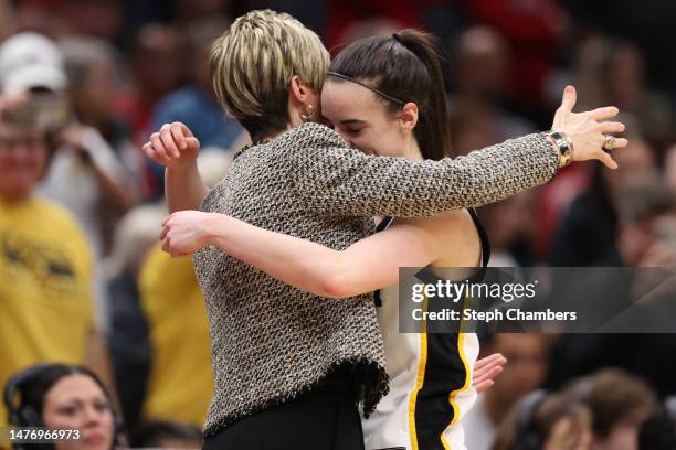 Associate Head Coach Jan Jensen and Caitlin Clark of the Iowa Hawkeyes celebrate after defeating the Louisville Cardinals in the Elite Eight round of...