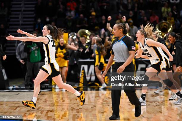 Caitlin Clark and Monika Czinano of the Iowa Hawkeyes celebrate after defeating the Louisville Cardinals 97-83 in the Elite Eight round of the NCAA...