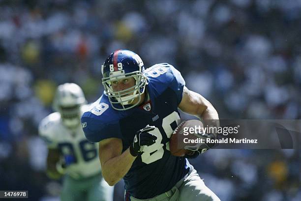 Tight end Dan Campbell of the New York Giants runs with the ball during the NFL game against the Dallas Cowboys on October 6, 2002 at Texas Stadium...