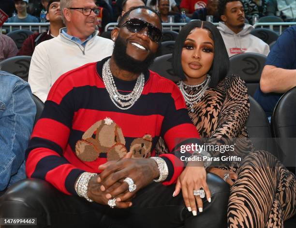 Rapper Gucci Mane and Keyshia Ka'Oir attend the game between the Memphis Grizzles and the Atlanta Hawks at State Farm Arena on March 26, 2023 in...