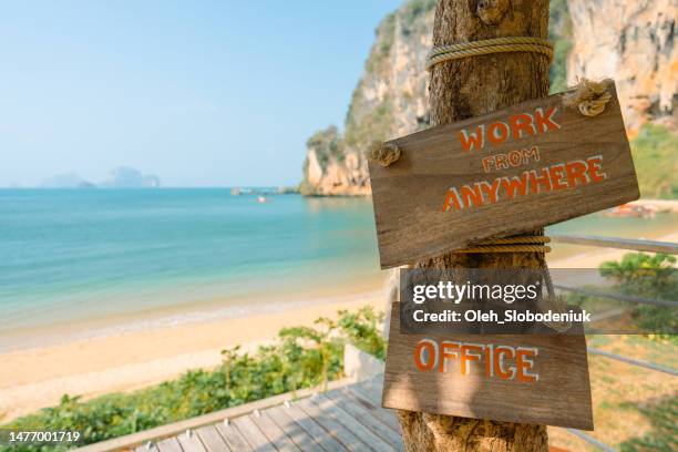 "work from anywhere" sign at the  seaside - railay strand stock pictures, royalty-free photos & images