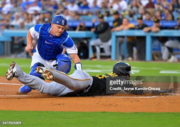 Will Smith of the Los Angeles Dodgers tags Carlos Santana of the Pittsburgh Pirates out as he tries to score from third in the second inning at...