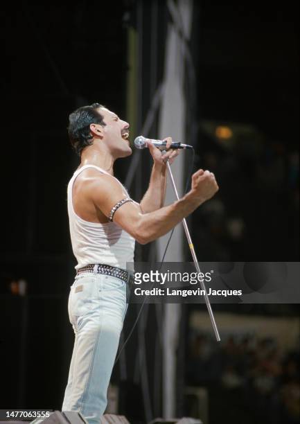 Singer Freddie Mercury of British rock group Queen performs at the Live Aid concert at Wembley Stadium in London, 13th July 1985. The concert raised...