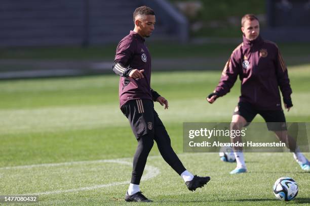 Thilo Kehrer of Germany plays the ball with his team mate Mario Götze during a training session of the German national team at DFB-Campus on March...