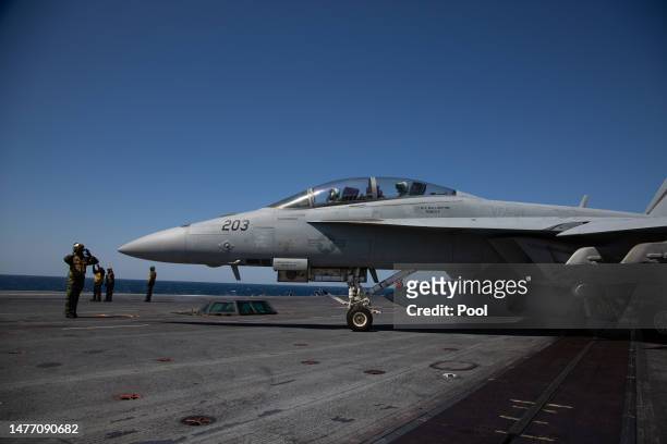 Navy F-18 Super Hornet and crew are seen on the flight deck of the USS Aircraft Carrier Nimitz during an South Korea and US combined maritime...