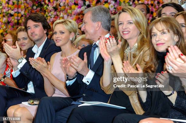 Natalia Vodianova, Antoine Arnault, Princess Charlene, Bernard Arnault, Delphine Arnault and Isabelle Huppert applaud after the Christian Dior...