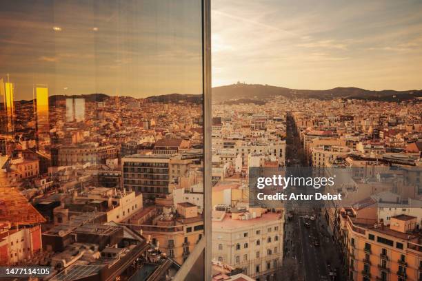 barcelona cityscape from above with the eixample straight streets and window glass reflection. - barcelona cityscape stock pictures, royalty-free photos & images