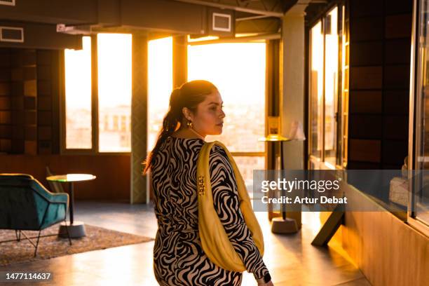 latin tourist woman in the hotel hall with bright light in the barcelona city. - home golden hour stock pictures, royalty-free photos & images