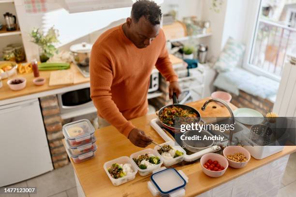man preparing healthy balanced vegetarian food - preparing food stock pictures, royalty-free photos & images
