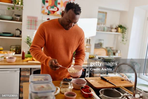 man preparing healthy balanced vegetarian food - meal stock pictures, royalty-free photos & images
