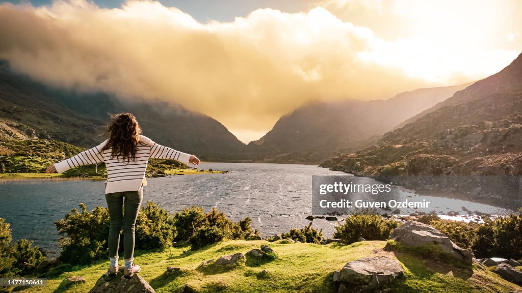 Aerial view of Gap of Dunloe, County Kerry, Ireland, woman watching lake from view point, being free in nature, strong woman in nature, woman saluting nature, cinematic nature photo, relaxation meditation nature, woman relaxing in nature
