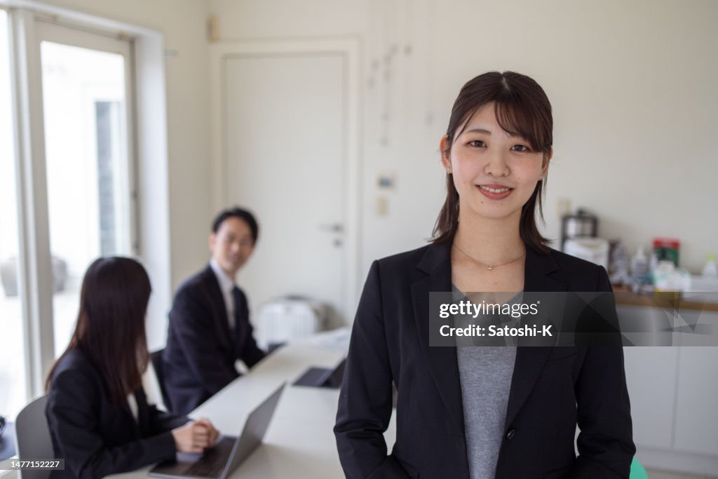 Portrait of young leader standing in meeting room
