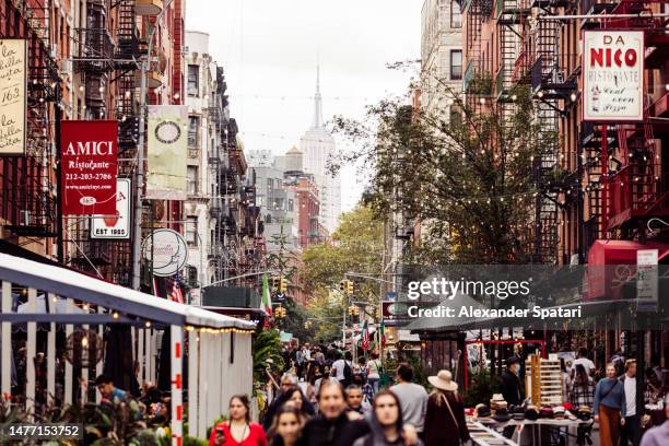 street with restaurants and crowds of people in little italy district, new york, usa - little italy stock pictures, royalty-free photos & images