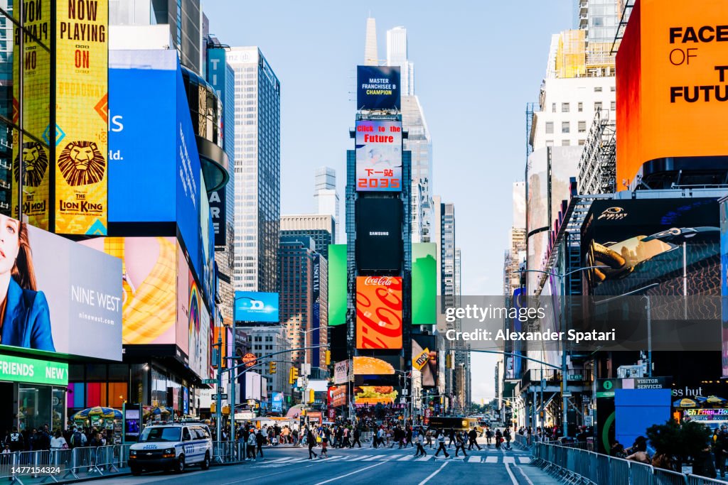 LED screens and billboards on Times Square on a sunny day, New York, USA