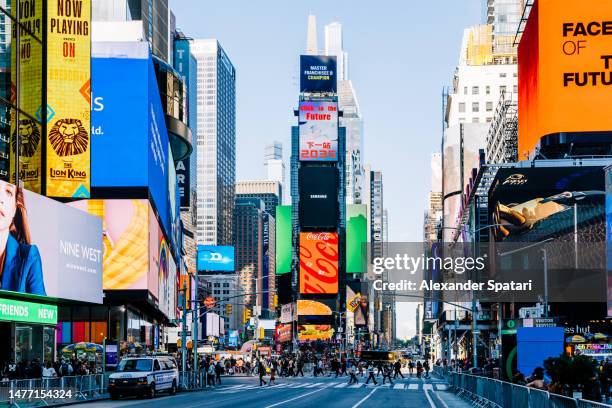 led screens and billboards on times square on a sunny day, new york, usa - insegna commerciale foto e immagini stock