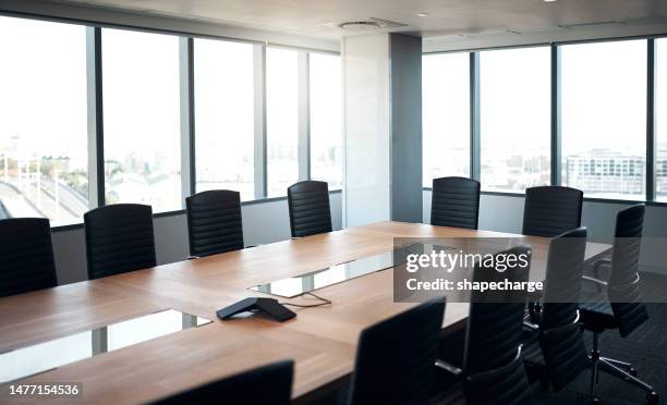 empty, meeting room and business building with chairs and a table for a workshop at a company. conference space, interior or workplace with new furniture and windows for mockup corporate office - business model strategy stockfoto's en -beelden