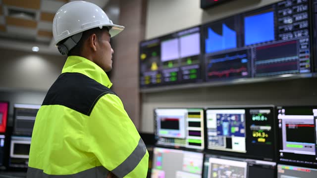 Engineer working at control room,Manager control system,Technician man monitoring program from a lot of monitor