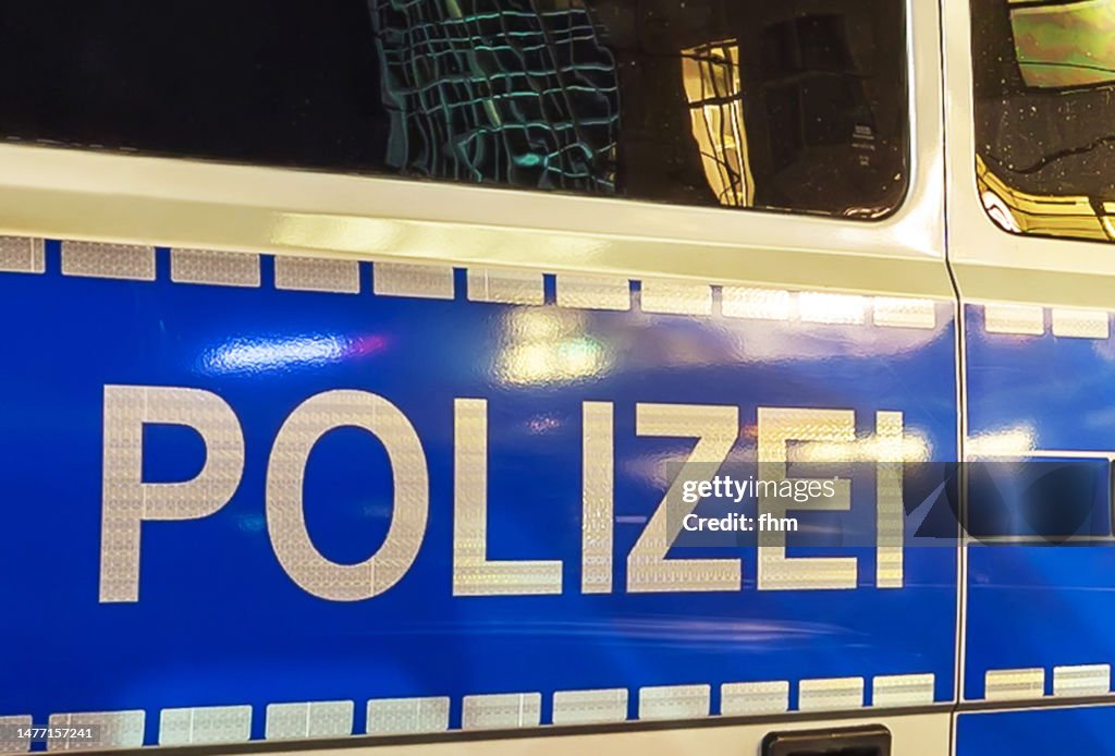 Police lettering on a police car at night