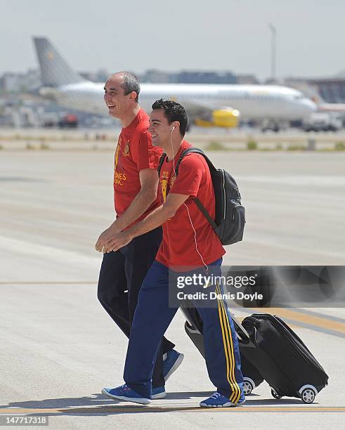 Spain's Xavi Hernandez arrives with an official and the rest of the team at Barajas airport on July 2, 2012 in Madrid, Spain. Spain beat Italy 4-0 in...