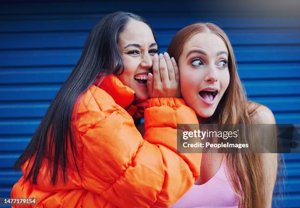 Friends, gossip in ear and women in laughing at secret joke in city with smile and shock on face. Urban secrets, rumor and whisper in ears, gen z woman and friend laugh at funny story on walk in town