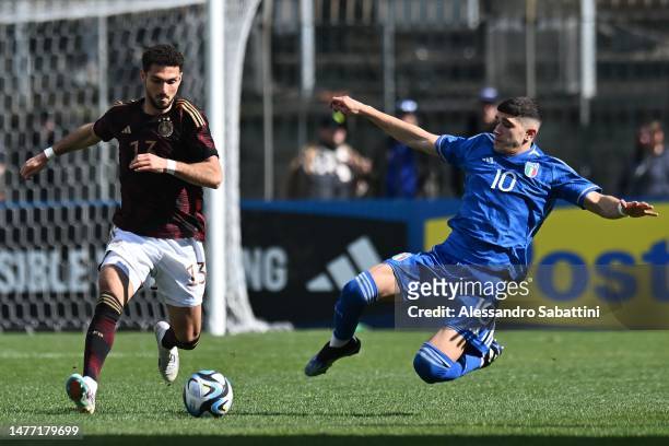 Kerim Clahanoglu of Germany U20 competes for the ball with Cristian Volpato of Italy U20 during the U20 international friendly match between Italy...