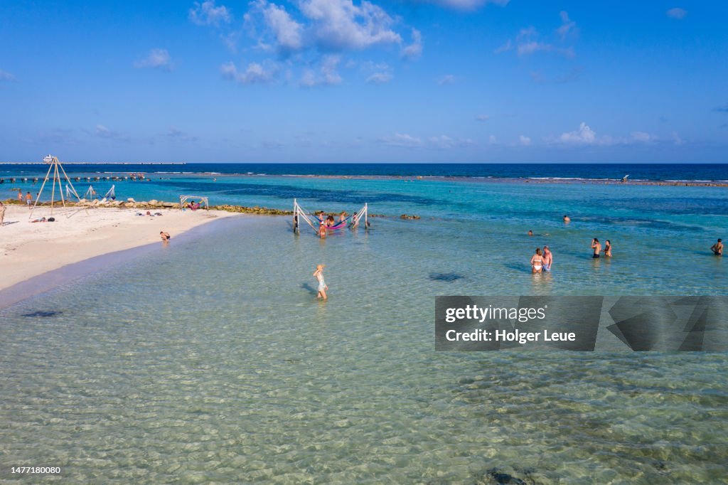 Aerial of people relaxing along beach and coastline