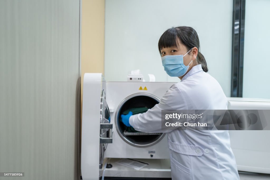 A female dentist is arranging medical instruments
