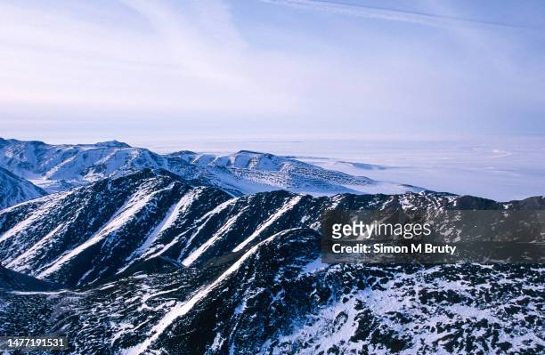 An aerial view from the Brooks mountain range towards the Beaufort Sea in the Arctic National Wildlife Refuge on March 28th, 2002 in Alaska, United...