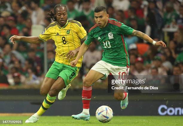 Daniel Johnson of Jamaica and Orbelin Pineda of Mexico fight for the ball during the match between Mexico and Jamaica as part Group A of the CONCACAF...