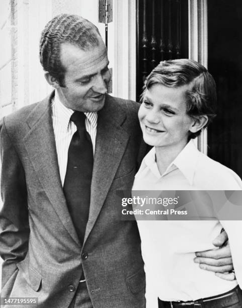 Spanish Royals Juan Carlos I, King of Spain, with his arm around the waist of his son, Felipe, Prince of Asturias at the Palacio de la Zarzuela in...