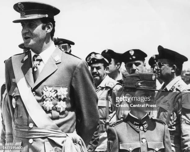 Spanish Royals Juan Carlos I, King of Spain, and his son, Infante Felipe of Spain, both in uniform, attend the ceremony where Felipe is inducted into...