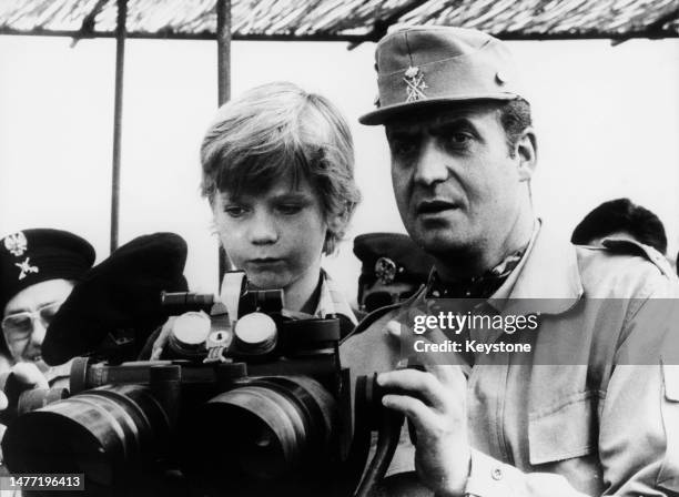 Spanish Royals Juan Carlos I, King of Spain, and his son, Felipe, Prince of Asturias use binoculars to observe military manoeuvres in Valverde in the...