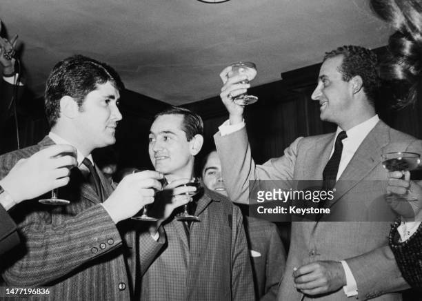 Spanish Royal Juan Carlos, Prince of Asturias, raises a glass with reporters following the birth of his son, Infante Felipe of Spain, at Our Lady of...